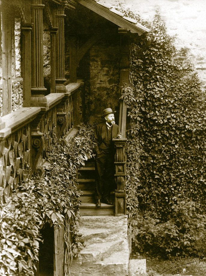 Max Weber, de pie y con barba, dando una conferencia ante un público sentado en el castillo de Lauenstein
